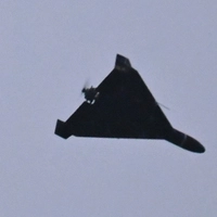 A photograph taken on December 27, 2025 shows an Iranian-designed Shahed 136, (Geranium-2) drone used by Russian Army flying over Kyiv during a Russian drones and missiles attack, amid the Russian invasion in Ukraine. A Russian drone and missile barrage on Kyiv and its suburbs killed one person, wounded two dozen and cut off heating and electricity for hundreds of thousands of people left in freezing temperatures on December 27, 2025. (Photo by Sergei SUPINSKY / AFP)