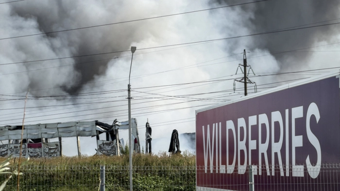 A plume of smoke rises during a fire at Russian e-commerce firm Wildberries' logistics complex near the town of Podolsk, outside Moscow on August 16, 2026. Hundreds of drones targeted Moscow on August 16, 2026 as Russia launched missile strikes that killed three people and wounded more than a dozen in Kyiv and other Ukrainian cities, officials on the two sides said. Ukraine has increasingly targeted warehouses linked to the Wildberries online retailer, arguing its strikes are a response to Moscow's bombardment of Ukrainian towns and infrastructure. (Photo by TATYANA MAKEYEVA / AFP)
