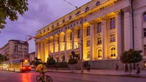 Sofia, Bulgaria - September 14, 2023: Evening view of the City Court building, with a tram, locals, and visitors, in Sofia, Bulgaria   xkwx architecture balkan bicycle building bulgaria bulgarian capital city cityscape classical column court court house courthouse culture cyclist europe european evening facade famous historic historical history house justice landmark legal legislation lion monument old palace road scene sculpture sofia statue street structure tourism town train tram travel urban