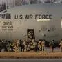 US soldiers disembark from a C-17 Globemaster cargo plane on the tarmac of Rzeszow-Jasionka Airport, south eastern Poland, on February 16, 2022. Dozens of US paratroopers landed at Rzeszow Airport in Poland -- part of a deployment of several thousand sent to bolster NATO's eastern flank in response to tensions with Russia. (Photo by Wojtek RADWANSKI / AFP) / ALTERNATIVE CROP