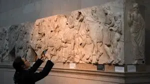 Visitors view the Parthenon Marbles, also known as the Elgin Marbles, at the British Museum in London on January 9, 2023. The ancient sculptures were taken from the Parthenon temple at the Acropolis in Athens in the early 19th century by British diplomat Thomas Bruce, the earl of Elgin. (Photo by Daniel LEAL / AFP) / RESTRICTED TO EDITORIAL USE