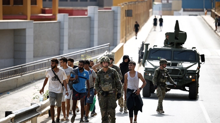 Spanische Soldaten eskortieren eine Gruppe von Migranten in Richtung marokkanischer Grenze