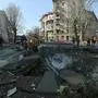 Ukranian municipal services workers survey and repair the damage following a missile attack in Kyiv, on March 21, 2024, amid the Russian invasion of Ukraine. (Photo by Sergei CHUZAVKOV / AFP)