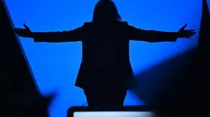 French far-right Rassemblement National (RN) party Member of Parliament and presidential candidate Marine Le Pen is seen in silhouette as she holds a campaign rally in Perpignan, southern France, on April 7, 2022. French voters head to the polls on April 10 and 24 for a two-round pesidential election. (Photo by LIONEL BONAVENTURE / AFP)