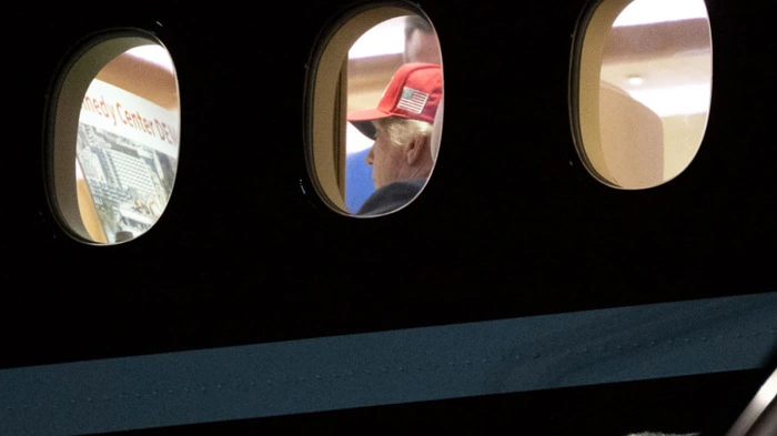 US President Donald Trump is seen aboard Air Force One checking a Kennedy Center large printout after landing at Joint Base Andrews, Maryland on September 16, 2026. Trump, who is returning from Gastonia, North Carolina after campaigning for Republican US Senate candidate Michael Whatley, threatened on September 15, 2026 to keep the Kennedy Center closed for good after a judge ruled his name cannot be added onto the famed arts institution's facade. (Photo by Brendan Smialowski / AFP)