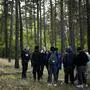 FILE - A Federal Police officer speaks into his radio as he and a colleague track down a group of migrants who have illegally crossed the border from Poland into Germany, while on patrol in a forest near Forst south east of Berlin, Germany, Wednesday, Oct. 11, 2023. Germany on Monday, Oct. 16, 2023 notified the European Union's executive branch of border controls at its frontiers with Poland, the Czech Republic and Switzerland, going a step beyond a move last month to strengthen checks on its eastern border. (AP Photo/Markus Schreiber, File)