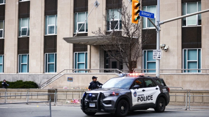 Toronto Police officers work around the scene of a shooting at the US Consulate in Toronto, Canada, on March 10, 2026. Shots were fired at the US consulate in Toronto early Tuesday but no one was injured, police said, days after Middle East war protests outside the building. The Toronto Police Service said it received reports of a firearm being discharged at the consulate before dawn in the downtown area of Canada's largest city. (Photo by Cole BURSTON / AFP)