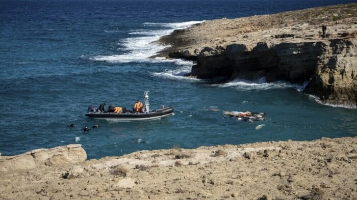 Greek coastguard rescuers recover a body from the sea off Kythira Island at the south of the Peloponnese peninsula on October 8, 2022. The death toll from the migrant boat wreck at the Greek island of Kythira, which prompted a dramatic cliffside rescue, has climbed to at least 11, the coastguard said on October 8, 2022. (Photo by Savvas Karmaniolas / AFP)