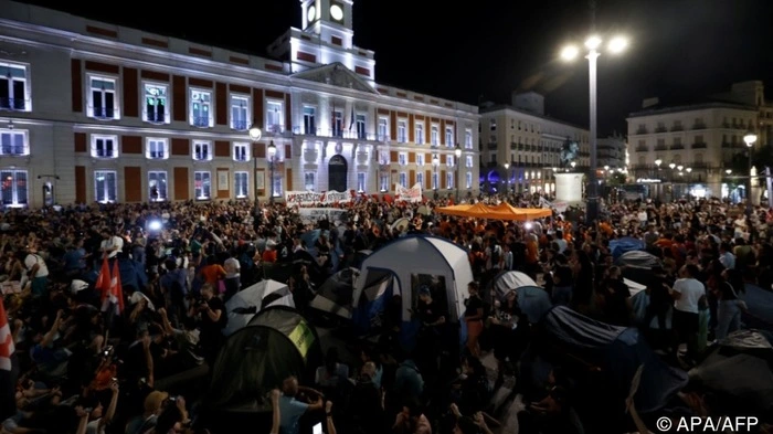 Demonstrators install tents during a protest against evictions and the housing crisis in front of the Presidency of the Community of Madrid on the Puerta del Sol plaza in Madrid on September 26, 2026. The sign reads: 'accessible housing'. Spain's main tenants' unions on September 25 urged the government to pass a new law to tackle the country's housing crisis after an 87-year-old was evicted from her Madrid home, sparking nationwide protests. (Photo by Oscar DEL POZO / AFP)