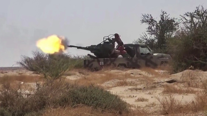 This frame grab taken from AFPTV video footage shows fighters affiliated with the Saudi-backed Yemeni government engaging in clashes with Houthi authorities in Al-Jawf province on September 15, 2026. The Saudi-led coalition battling Yemen's Houthi authorities accused them on September 16 of targeting Islam's holy city Mecca, sparking outrage across the Muslim world. Houthi authorities swiftly rejected as a "lie" Riyadh's statement that it had shot down a drone heading towards Mecca, which attracts millions of pilgrims each year. Fresh fighting between the Iran-backed Houthi authorities and Yemen's Saudi-backed internationally recognised government has dragged in the kingdom, with the Houthi authorities declaring a maritime blockade on its ships in the Red Sea. (Photo by AFPTV / AFP)