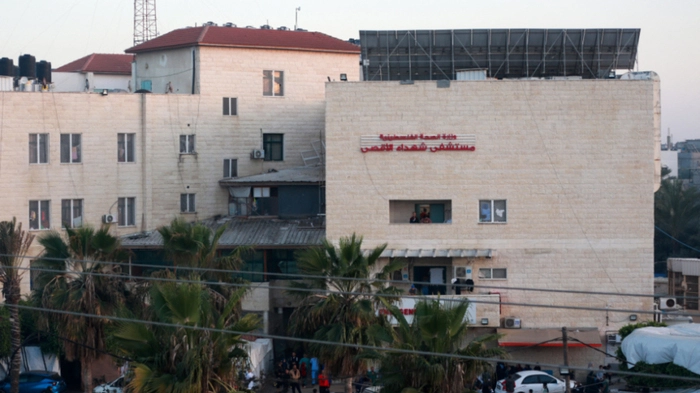 People stand in front of the Shuhada al-Aqsa Hospital in Deir el-Balah in the central Gaza Strip on April 3, 2024, amid the ongoing conflict between Israel and the Palestinian militant group Hamas. (Photo by AFP)