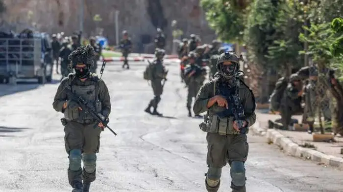 Israeli soldiers patrol a street as they are deployed during an operation in the village of Qusra, south of Nablus, in the Israeli-occupied West Bank, on August 13, 2026. Israeli forces on August 13 moved against rogue settlers laying siege to Palestinians amid unusually strong US criticism, even as Israel inaugurated an emblematic settlement elsewhere in the West Bank. Settlers at Qusra near Nablus since August 9 have blockaded Palestinian homes, including one owned by a US citizen, with residents saying they have been cut off from food and other supplies. (Photo by Zain JAAFAR / AFP)