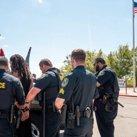 PFLUGERVILLE, TEXAS - SEPTEMBER 22: Pflugerville Police Department officers detain a person during a protest on September 22, 2026 in Pflugerville, Texas. Students from several high schools across Austin are participating in walkouts and protests in response to Sunday's shooting where a federal ICE officer shot and wounded 28-year-old Wilber Rafael Garces Perez, a Venezuelan national who was working as a DoorDash driver in North Austin. Brandon Bell/Getty Images/AFP (Photo by Brandon Bell / GETTY IMAGES NORTH AMERICA / Getty Images via AFP)