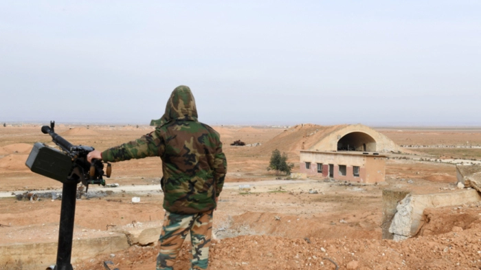 (FILES) A member of Syrian government forces, stands guard the Abu Duhur military air base area in Idlib province, on January 21, 2018. Syria's foreign ministry condemned what it said was an unjustified Israeli attack on an air base in the country's northwest on August 18, 2026, while Israel has not commented on the incident. (Photo by George OURFALIAN / AFP)