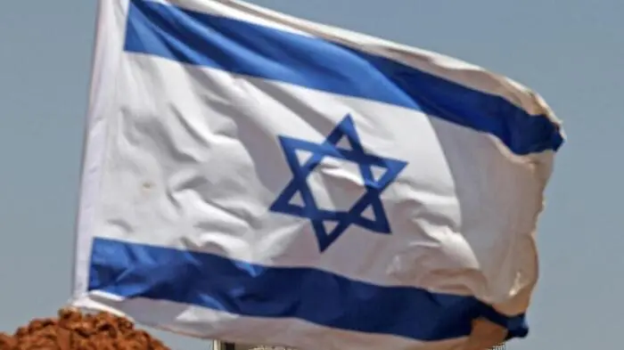 An Israeli flag installed by settlers is pictured in Beit Sahur, south of Bethlehem, in the occupied West Bank on August 14, 2026. Violence against Palestinians by Israeli settlers in the West Bank has increased dramatically since the October 7, 2023 attack on Israel by Hamas from the Gaza Strip. More than 500,000 Israelis live in settlements in the West Bank, which are illegal under international law, among some three million Palestinians in the territory. (Photo by AHMAD GHARABLI / AFP)