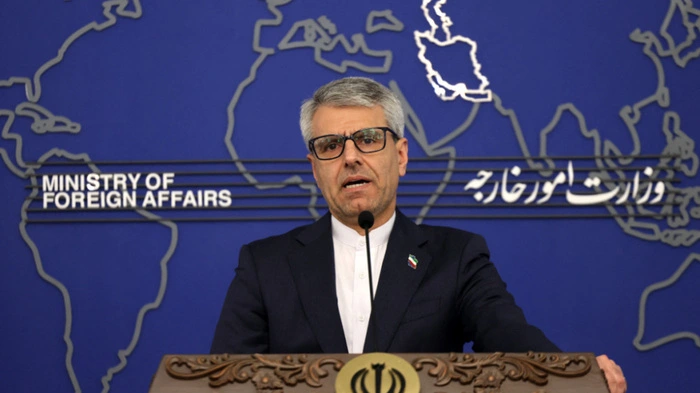 Iranian foreign ministry spokesman Esmail Baqaei responds to reporters on his country's foreign policy agenda and regional developments during the weekly press conference held at the Ministry of Foreign Affairs in the capital Tehran, on February 10, 2026. Iran warned on February 10 of "destructive" influence on diplomacy ahead of Israeli Prime Minister Benjamin Netanyahu's visit to Washington for talks expected to focus on US negotiations with Tehran. "Our negotiating party is America. It is up to America to decide to act independently of the pressures and destructive influences that are detrimental to the region," said Iranian foreign ministry spokesman Esmail Baqaei in a weekly press briefing. (Photo by ATTA KENARE / AFP)