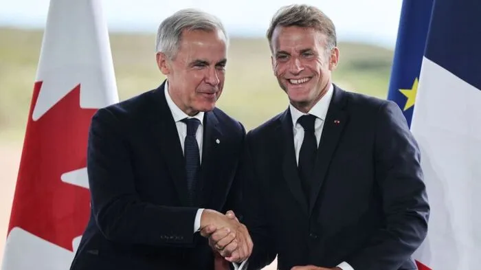 France's President Emmanuel Macron (R) and Canada's Prime Minister Mark Carney (L) hold a joint press statement in Saint-Pierre on September 20, 2026, during Macron's visit to the French self-governing overseas collectivity of Saint-Pierre-et-Miquelon. French President Emmanuel Macron said France and Canada were "two great independent nations who want to stay that way" in a joint news conference with Canadian leader Mark Carney on September 20, 2026. Carney, visiting France's tiny North Atlantic territory of Saint Pierre and Miquelon just off the Canadian coast, said the moment had come to tighten links with France and the European Union. (Photo by Ludovic MARIN / AFP)