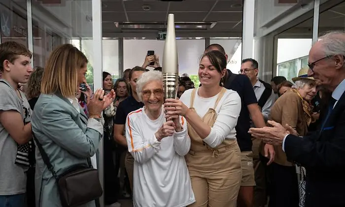 Berger-Volle mit der olympischen Fackel