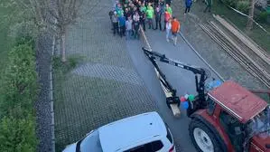 Die Situation aus der Vogelperspektive: Der Maibaum liegt am Boden, die Männer zum Aufstellen stehen bereit, doch ein Auto parkt über dem Loch