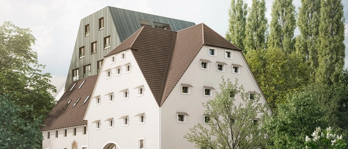 Die Rottalmühle in der Körösistraße im Vordergrund, der neue Wohnbau im Hintergrund