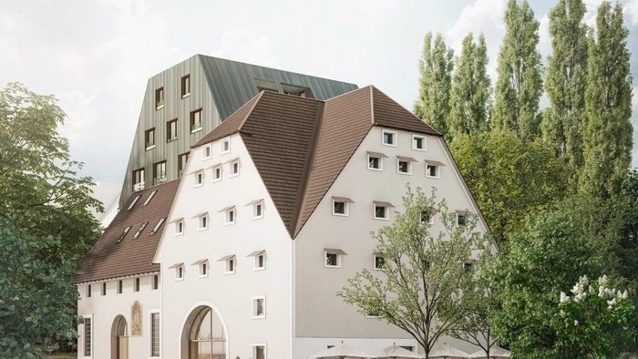 Die Rottalmühle in der Körösistraße im Vordergrund, der neue Wohnbau im Hintergrund