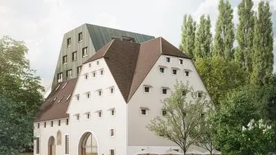 Das ehemalige Mühlengebäude und der geplante Neubau von der Körösistraße aus gesehen.  