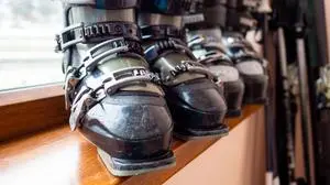Ski boots rental, skis and poles. Skiing equipment rented. Close up