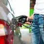 Refuel the car on a gas station; man holding the tap