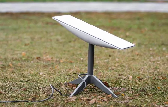 An antenna for receiving the Internet signal from space Starlink on the ground in the park
