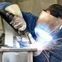 welder works in metal construction - construction and processing of steel components 